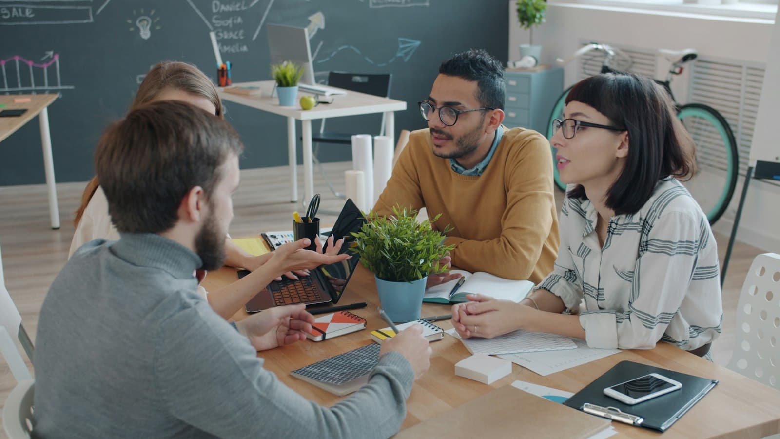 Digital Aimission strategists collaborating around a workspace table
